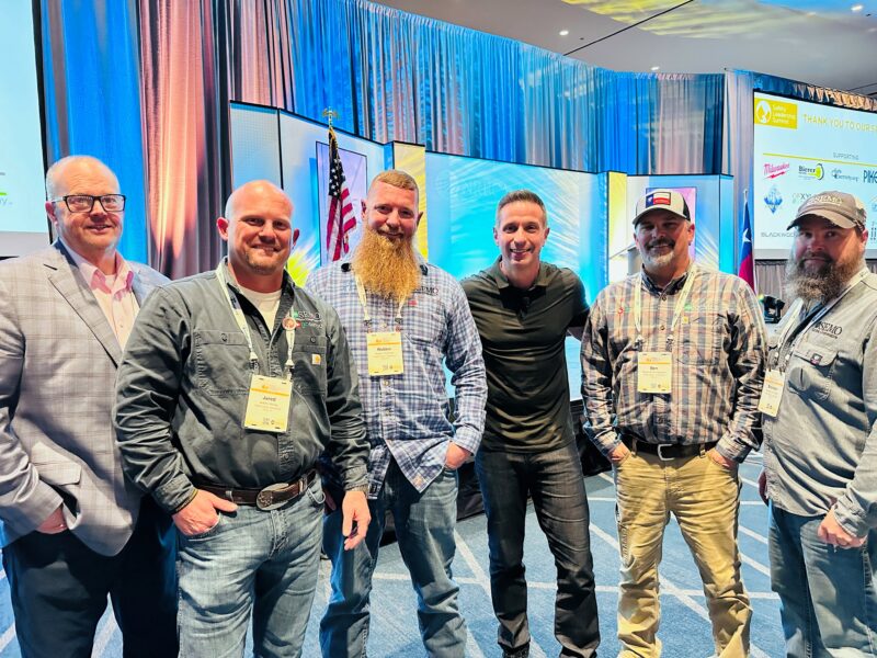 Photo: During the conference, (left to right) Sean, Jared, Robbie, Ben, and Brandon spent a moment with keynote speaker Damon West (center). A former college quarterback, Damon fell into meth addiction and organized crime, leading to a life sentence in a Texas prison. During his incarceration, he transformed his life, inspired by the metaphor of a coffee bean that changes its environment. Although released, Damon remains on parole until 2073. 